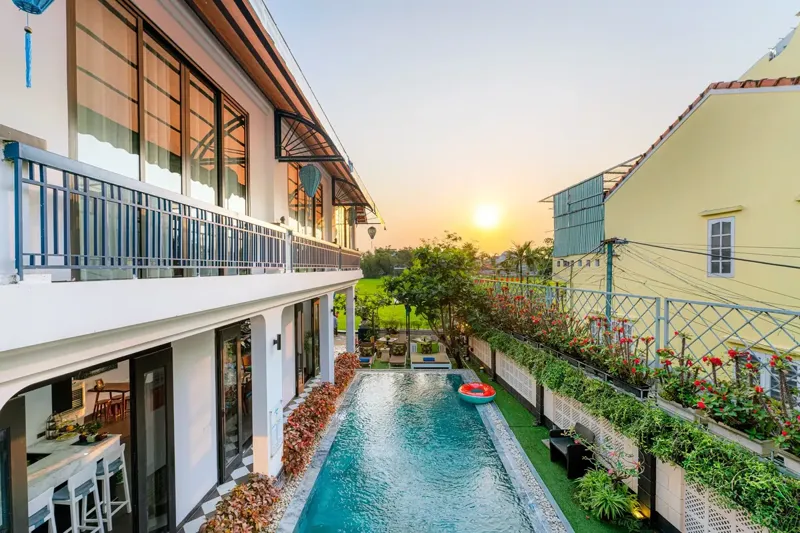 Swimming pool at Lavini Hoi An Boutique Villa at sunset