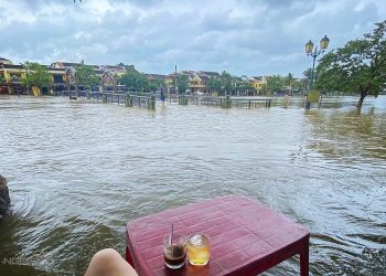 Hoi An residents sip coffee sitting in floodwater