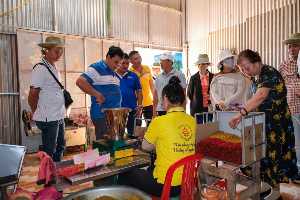 Tourists learning the intricate art of rolling incense.